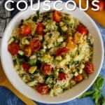 Pin for pinterest with overhead view of white casserole dish filled with finished couscous recipe on a blue background. Text on top "Easy couscous side dish recipe"