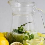 Pin for pinterest graphic with image of cucumber lemonade and text on top.