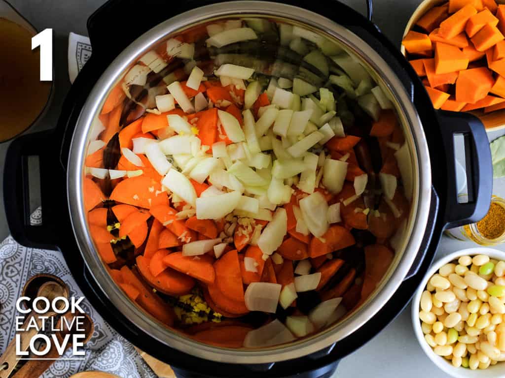 Onions, carrots and garlic are added to instant pot to saute.