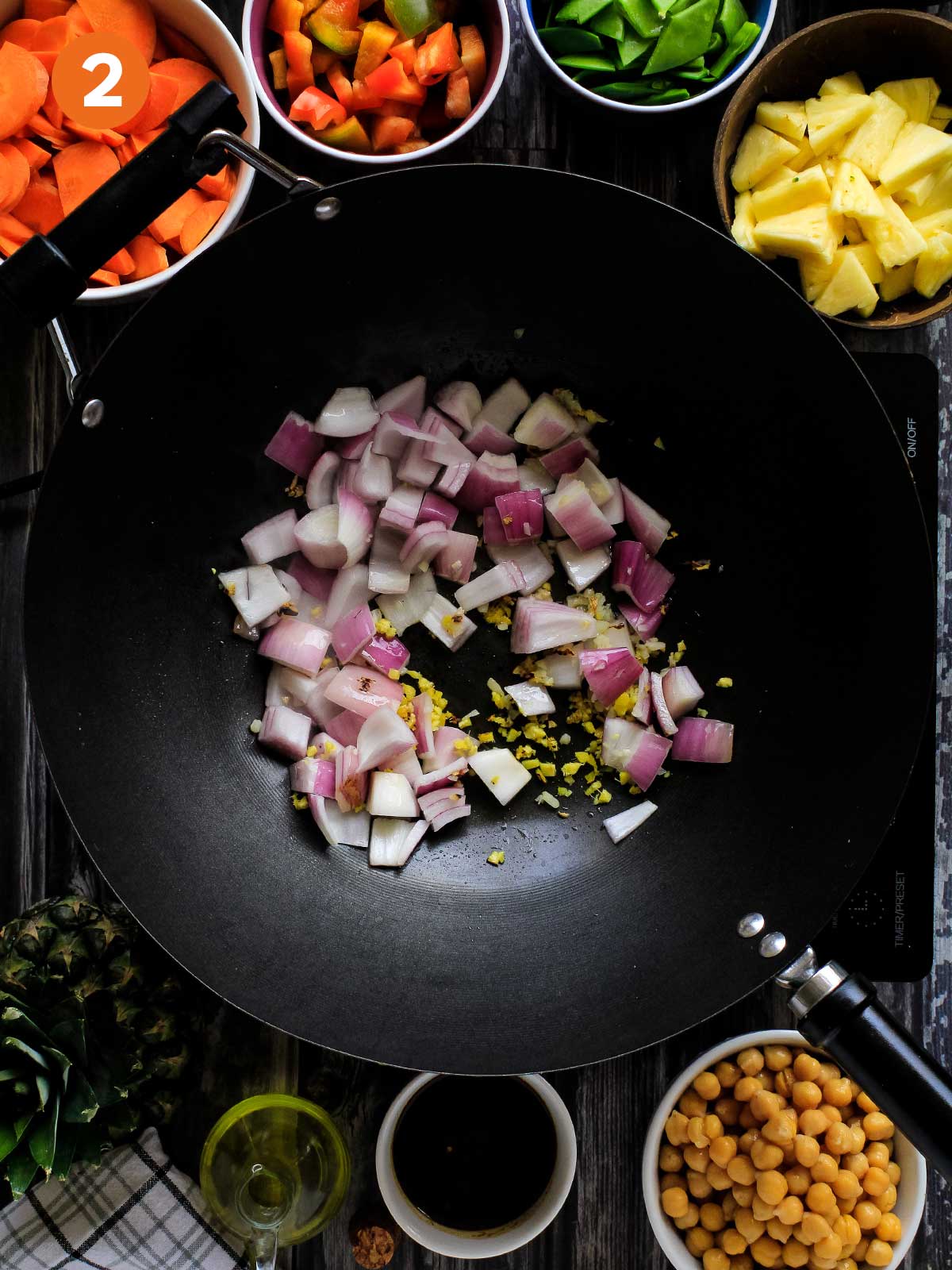 Cooking the onions, garlic and ginger in a wok.