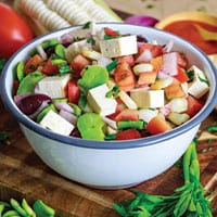 Front view of solterito salad in white bowl.