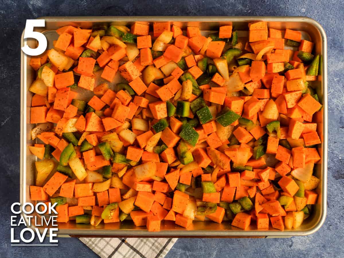 Sweet potato hash on a sheet pan ready for the oven.