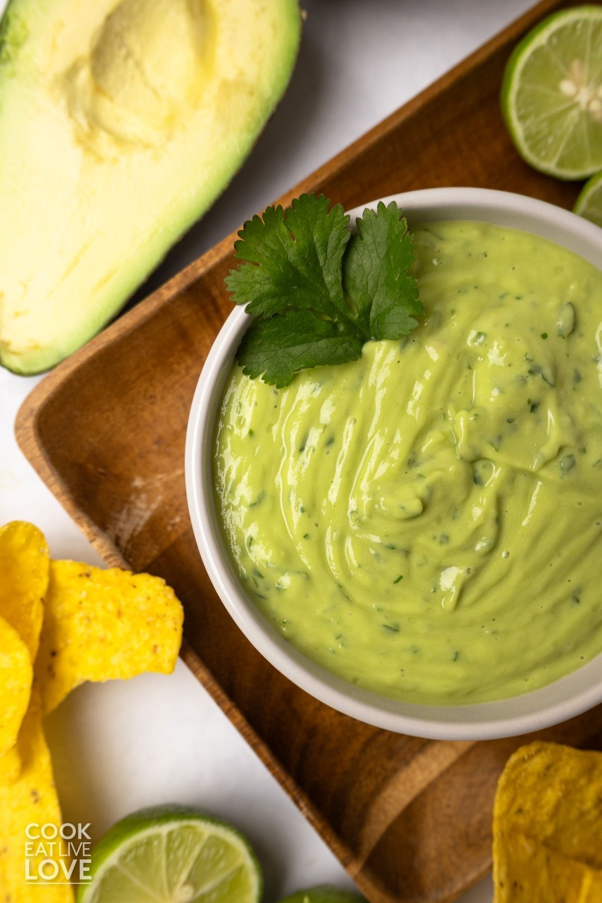 A bowl of avocado sauce for tacos in a bowl garnished with cilantro.