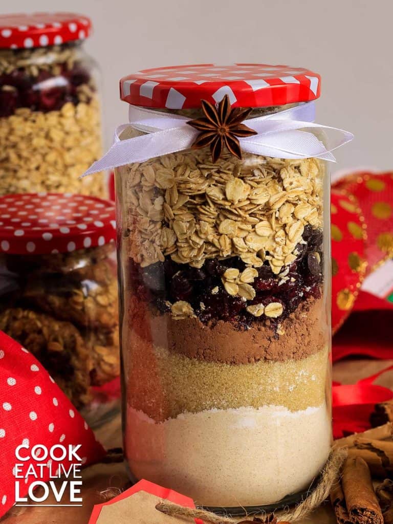 Cookie gift jars with layers of ingredients are assembled, decorated and ready to give for gifts.