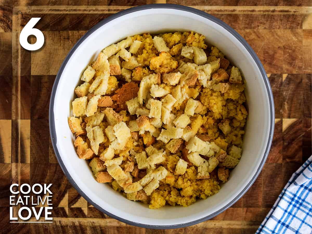 Cornbread and breadcrumbs are placed in a mixing bowl to make gluten free cornbread stuffing.