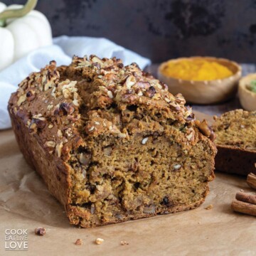 Loaf of pumpkin zucchini bread with front cut to show inside.