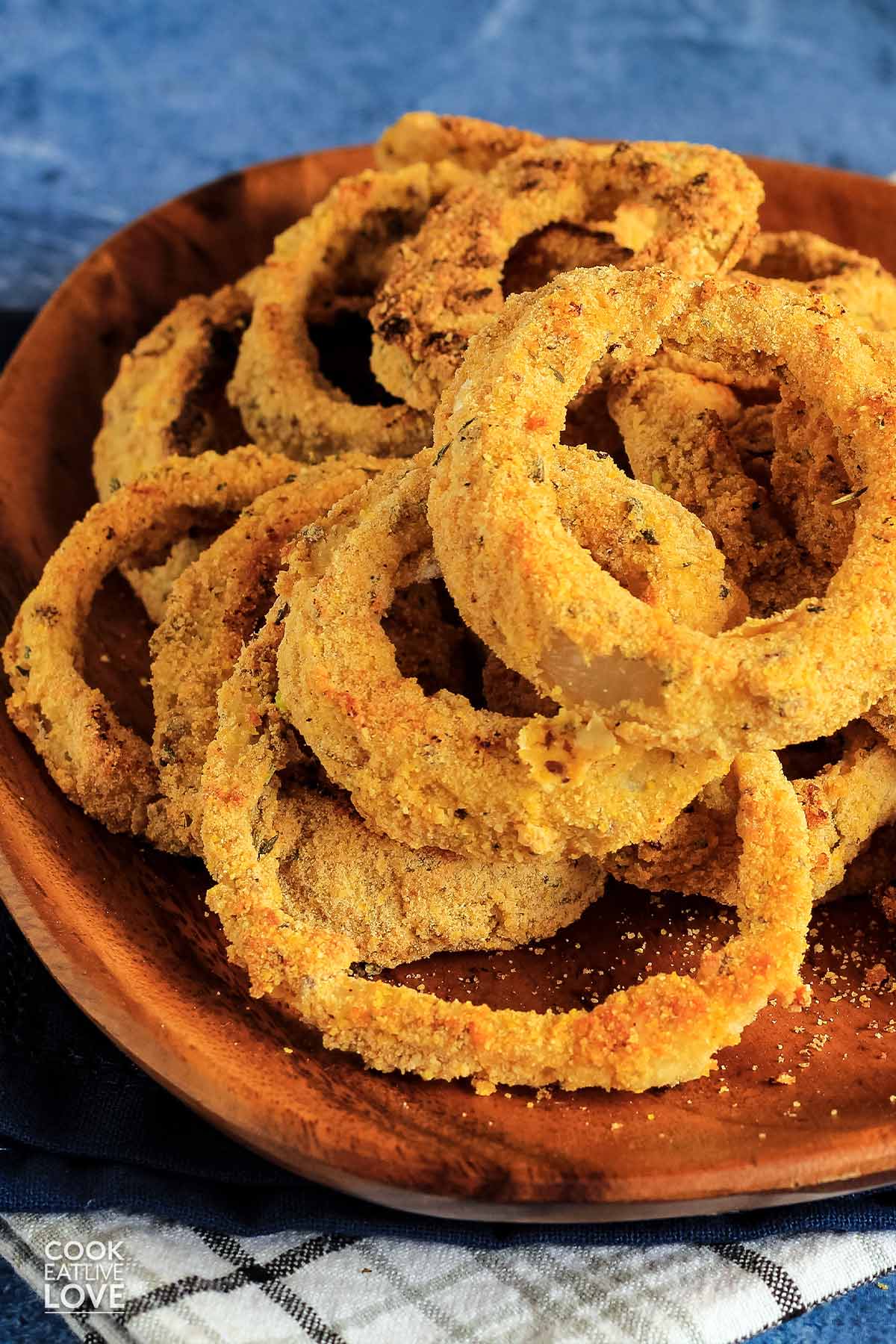 Plate of vegan baked onion rings with ketchup.