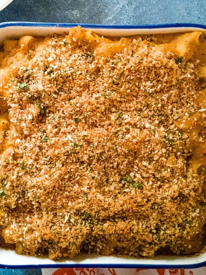 Casserole dish of macaroni and cheese with breadcrumb topping.