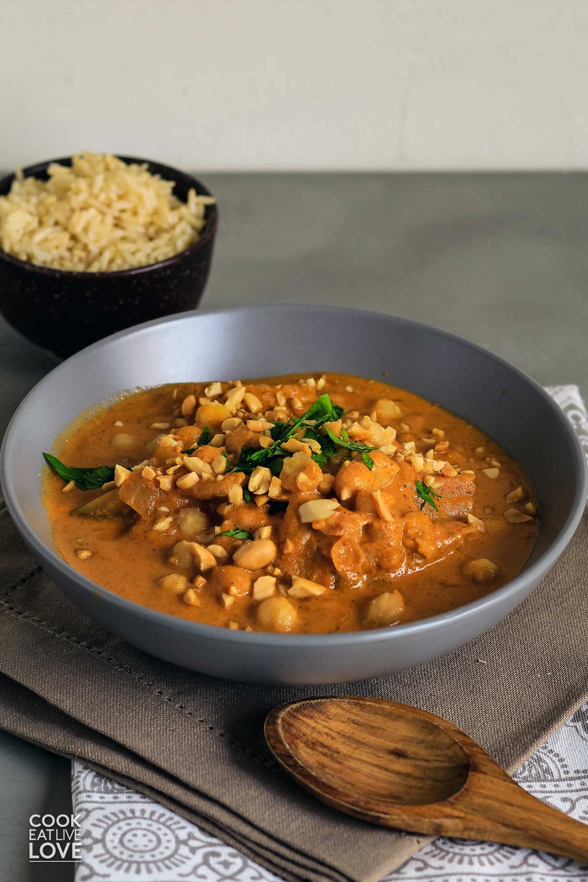 Vegetarian massaman curry served up in gray bowl with rice.