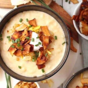 Brown bowl of potato soup with veggie bacon on top.