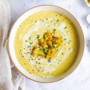 Creamy cauliflower soup with cream drizzle and croutons.