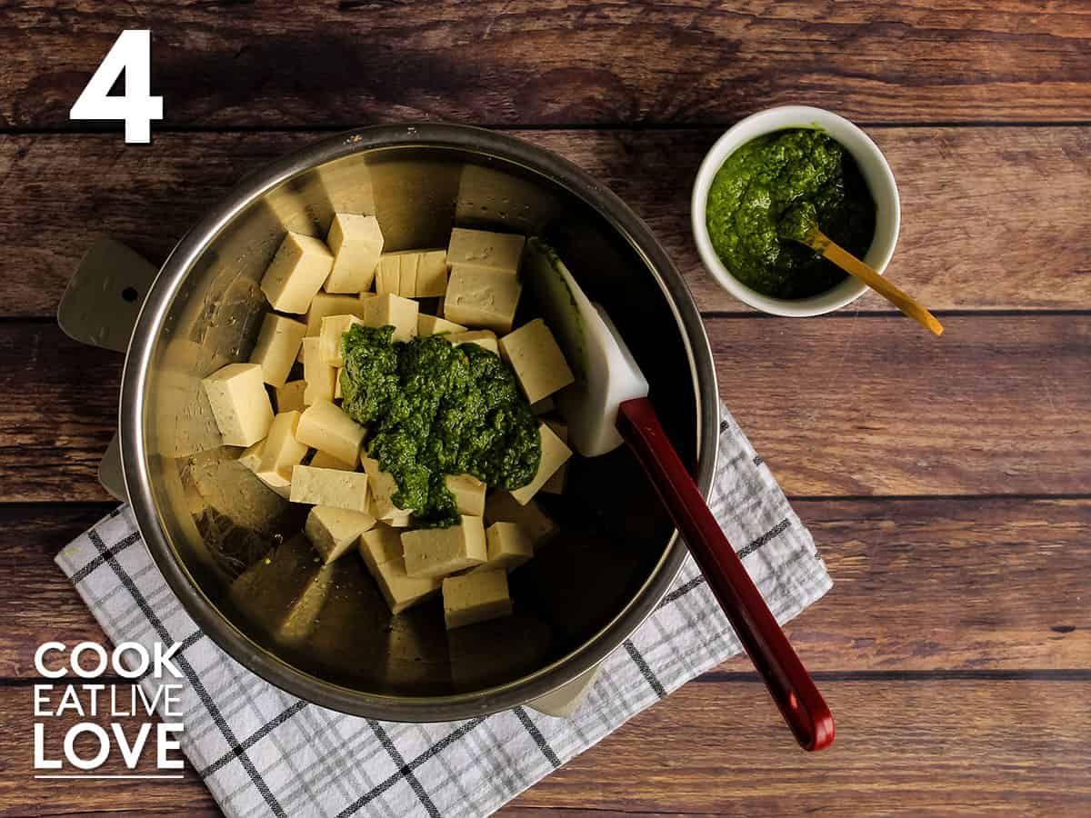 Tofu in a bowl with pesto added.