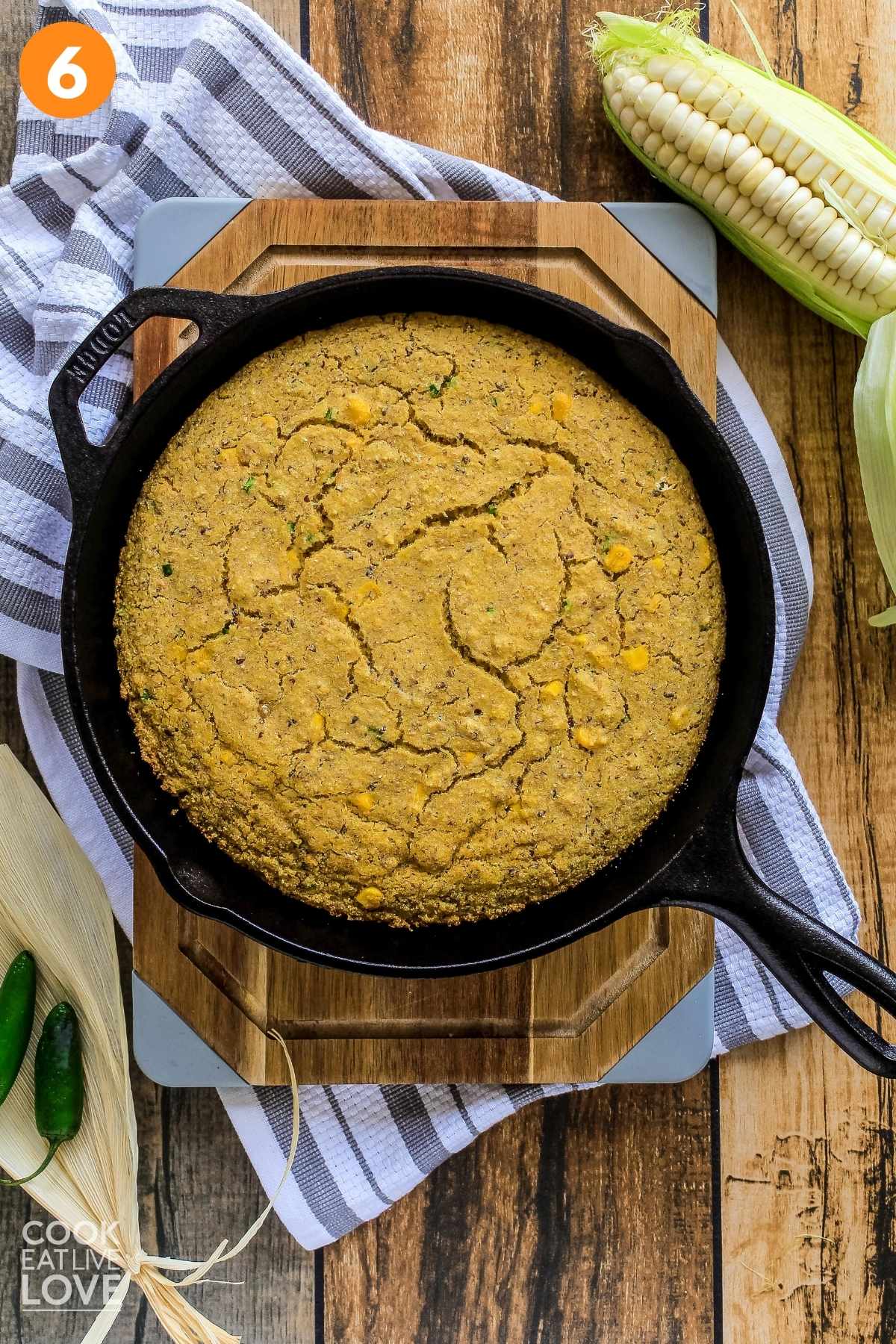 Baked vegan cornbread in a skillet on the table.