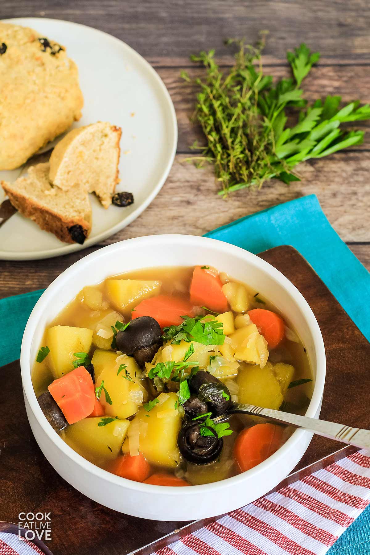 Bowl of vegan Irish stew on table with spoon