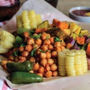 Chickpeas and veggies served up on a plate lined with paper