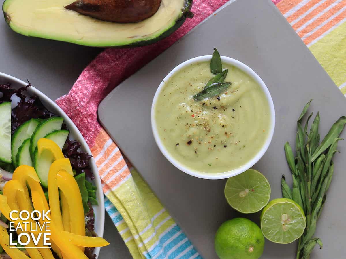 Avocado lime dressing in a white bowl on the table
