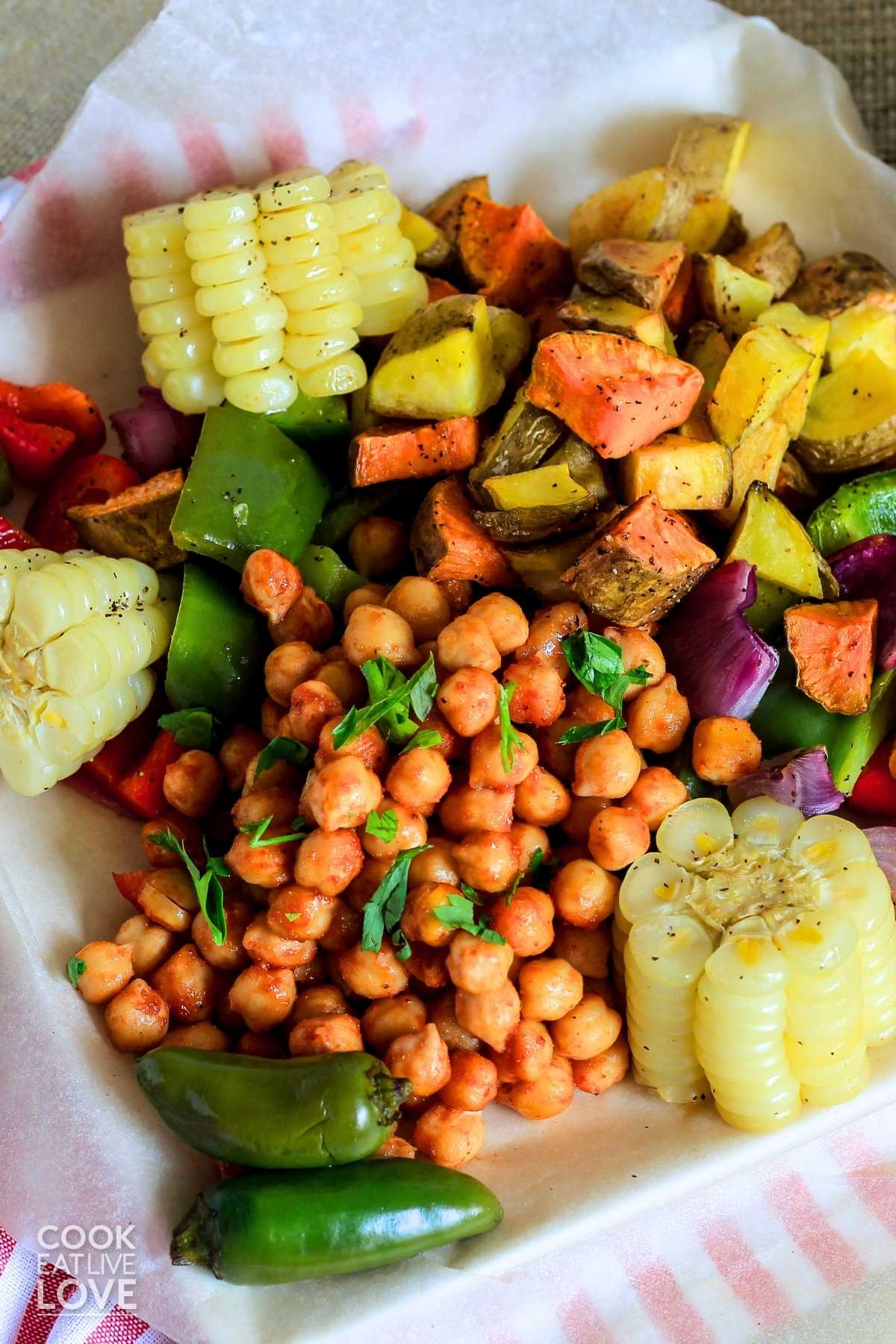 BBQ chickpeas and veggies served up on a white platter.