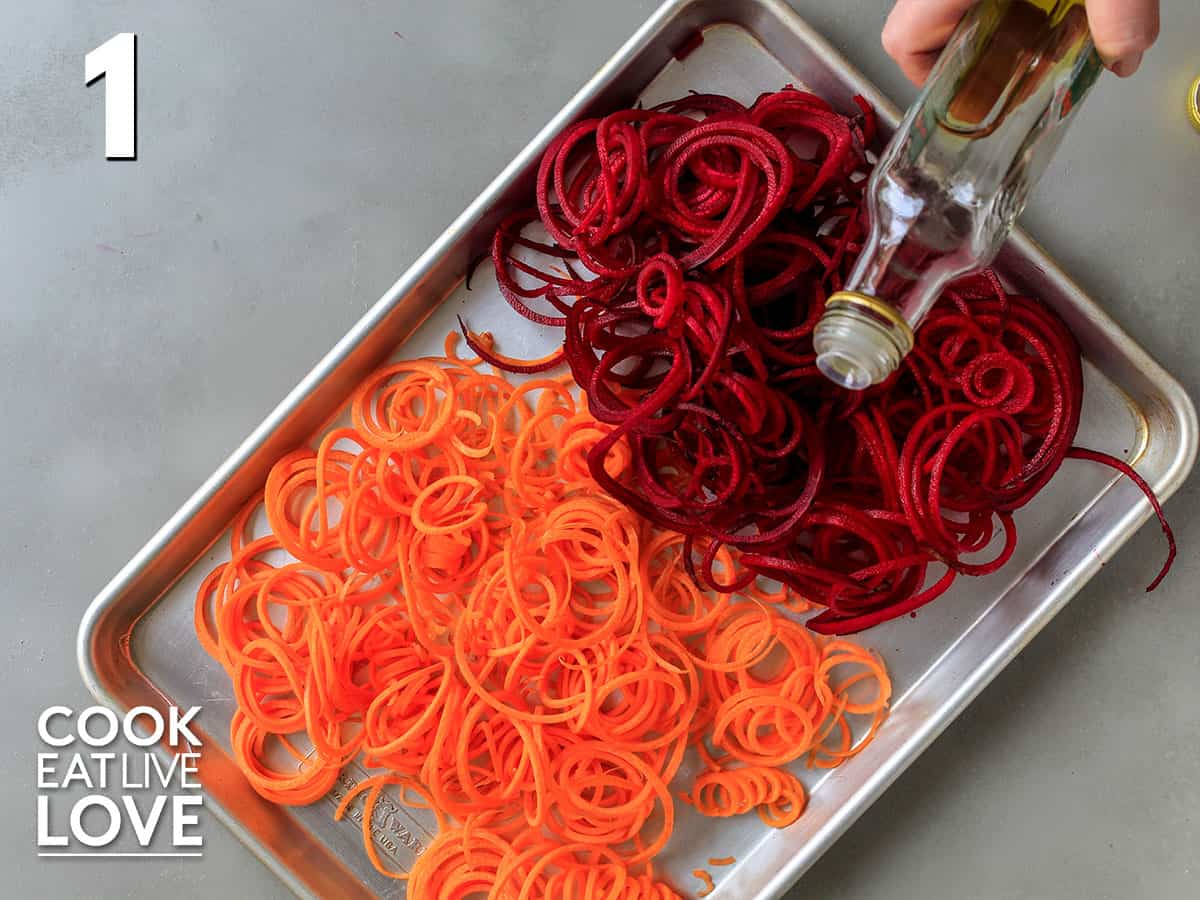 Spiralized carrots and beets on a baking sheet