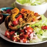 Vegetarian burrito bowls served up on a plate with toppings