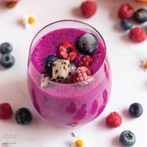 Purple dragon fruit smoothie with straw in glass