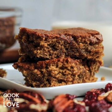 Two vegan blondies stacked on a plate