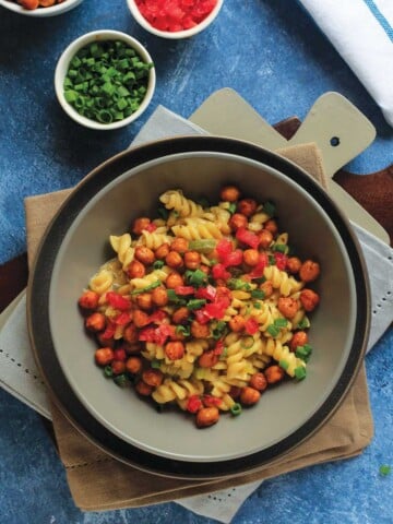 Cajun pasta in a gray bowl with fork