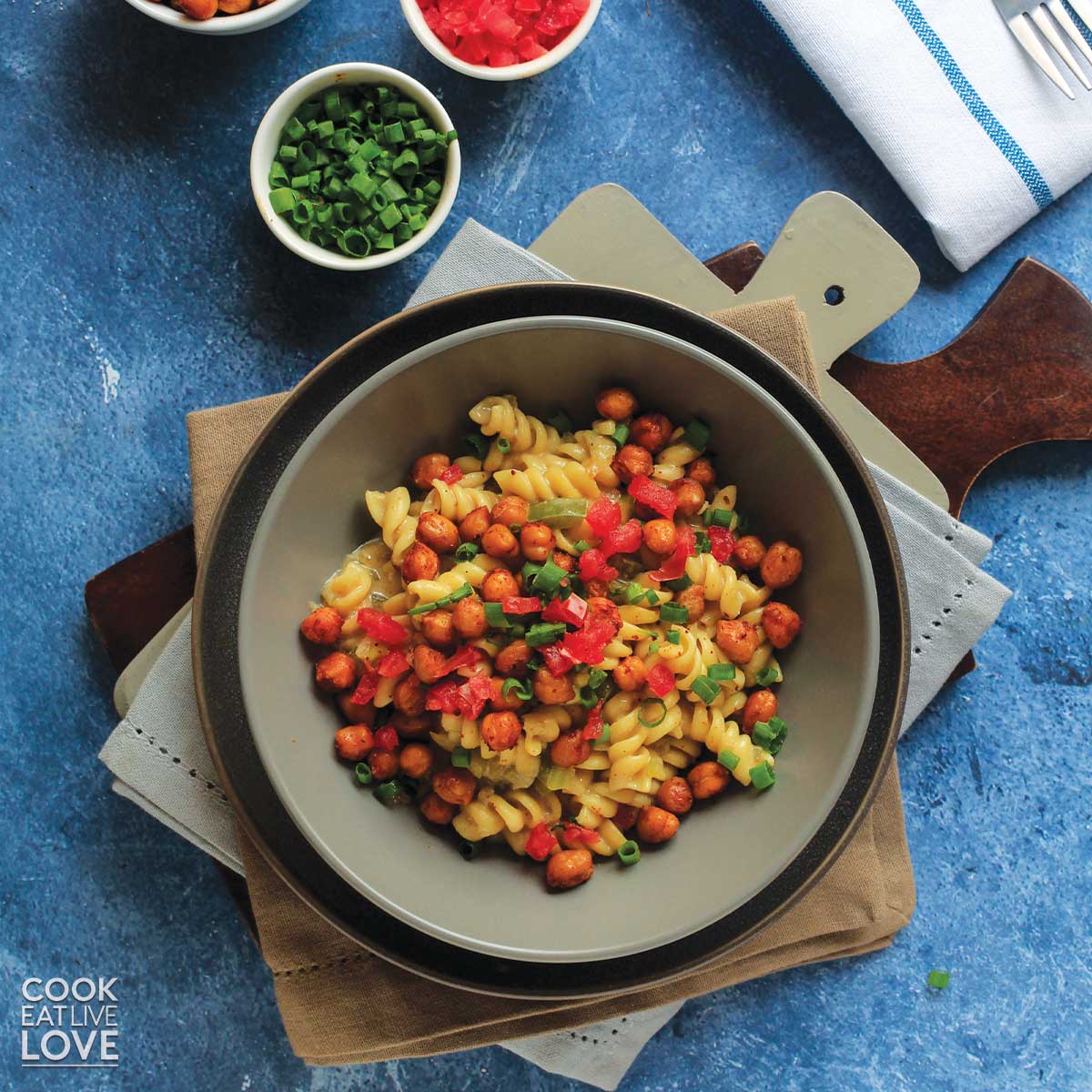 Cajun pasta in a gray bowl with fork