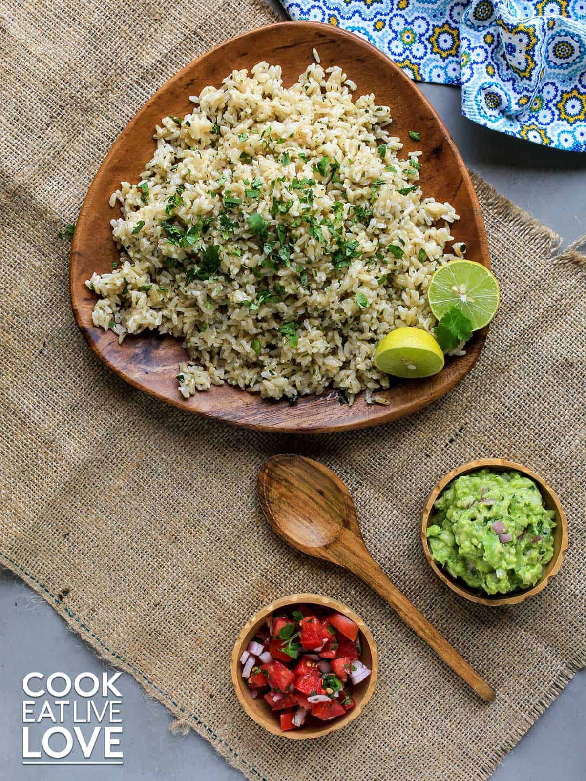 Brown wooden plate with coconut lime brown rice on the table