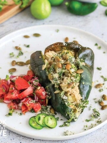 Vegetarian stuffed poblano pepper on a white plate