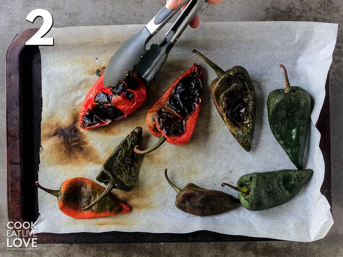 Turning poblano peppers over with tongs