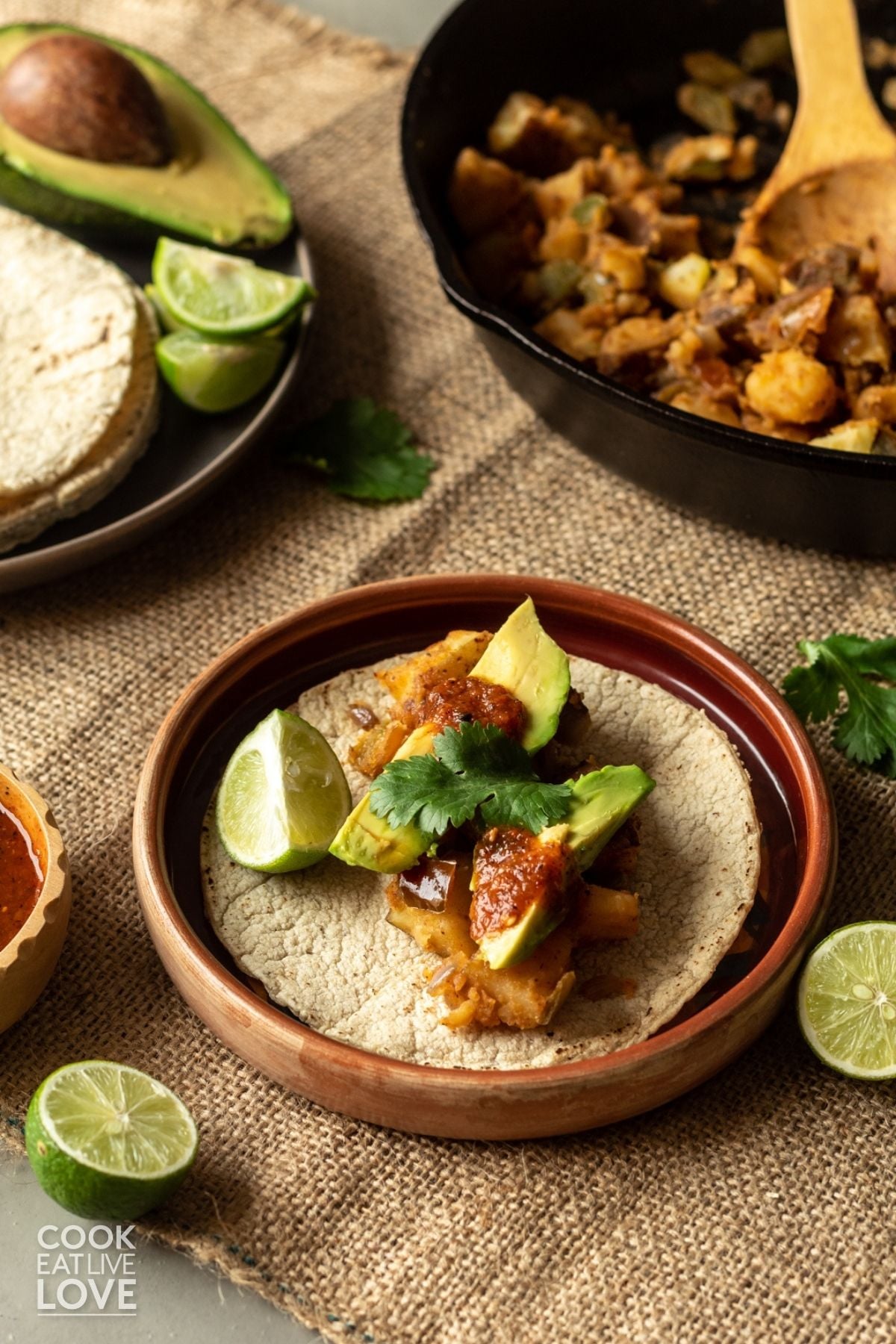 Potato tacos on a plate and in a skillet. 