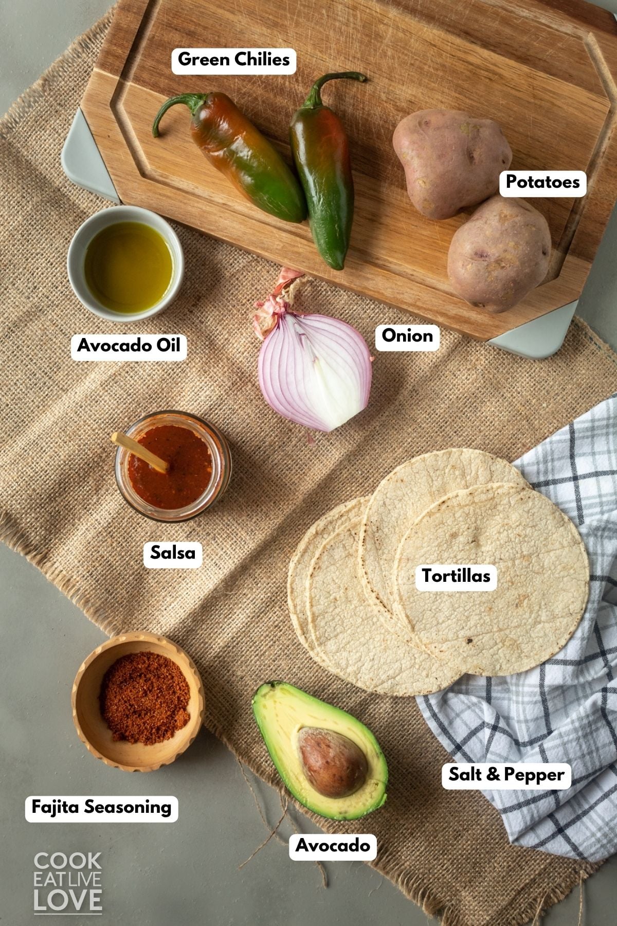 Ingredients to make potato tacos on a table with labels to identify each. 