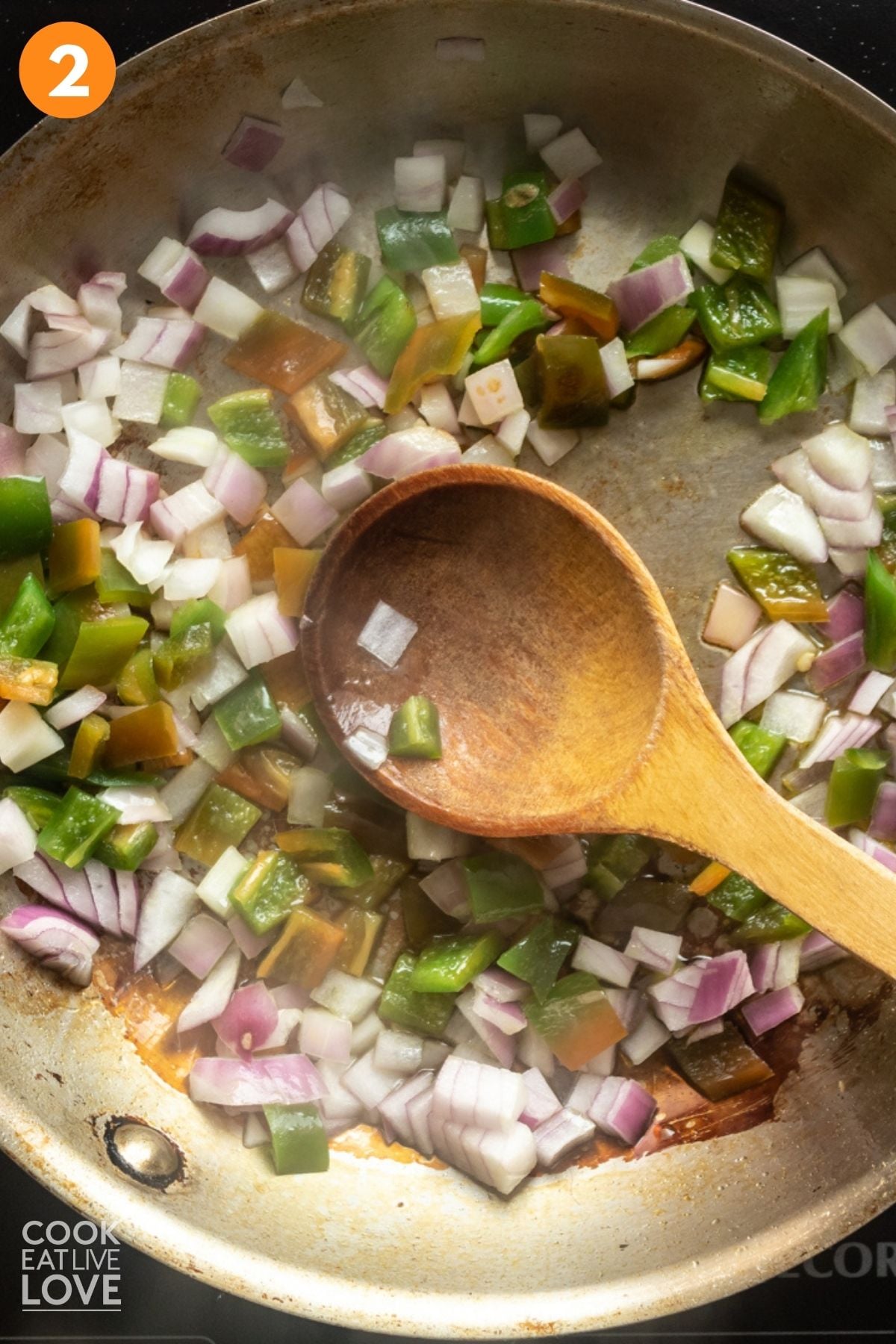 Cooking the green chilies and onion. 