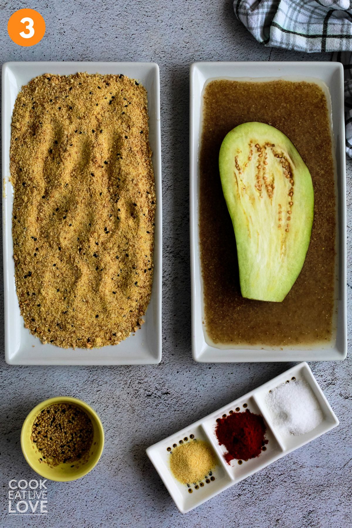 Eggplant in flax and water liquid and a plate of breadcrumbs next to it. 