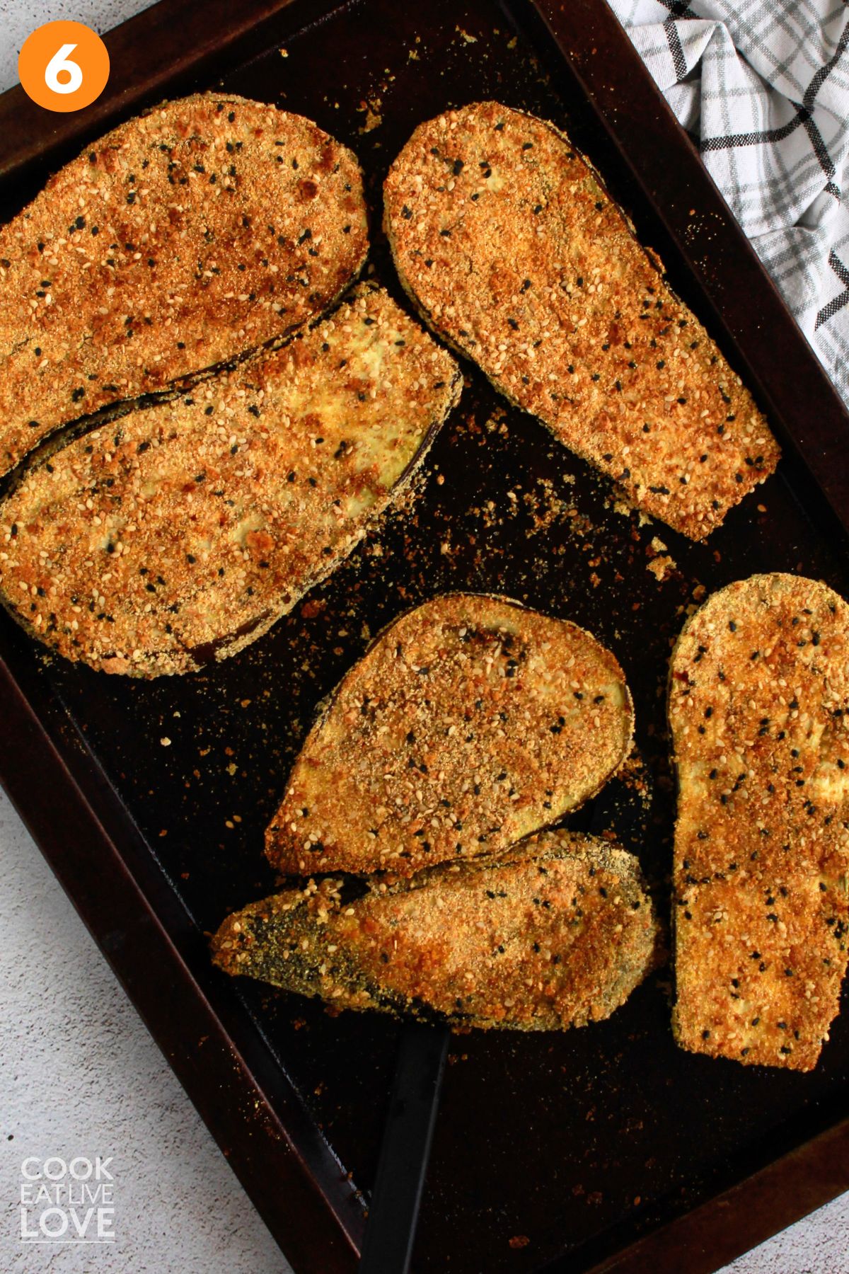 Crispy breaded eggplant on a baking tray. 