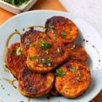 A pin for pinterest graphic with image of sweet potatoes on a plate with text on top.