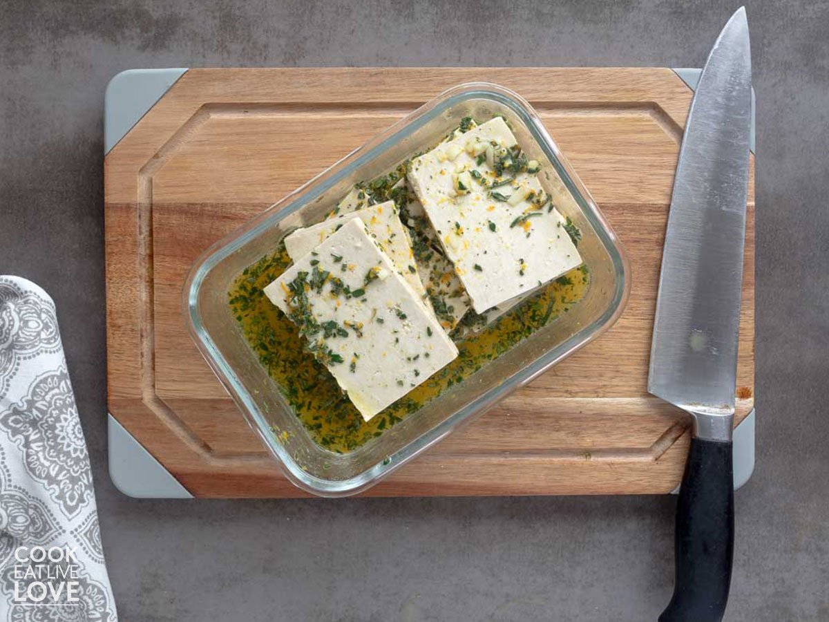 Tofu in a container with marinade poured over the top