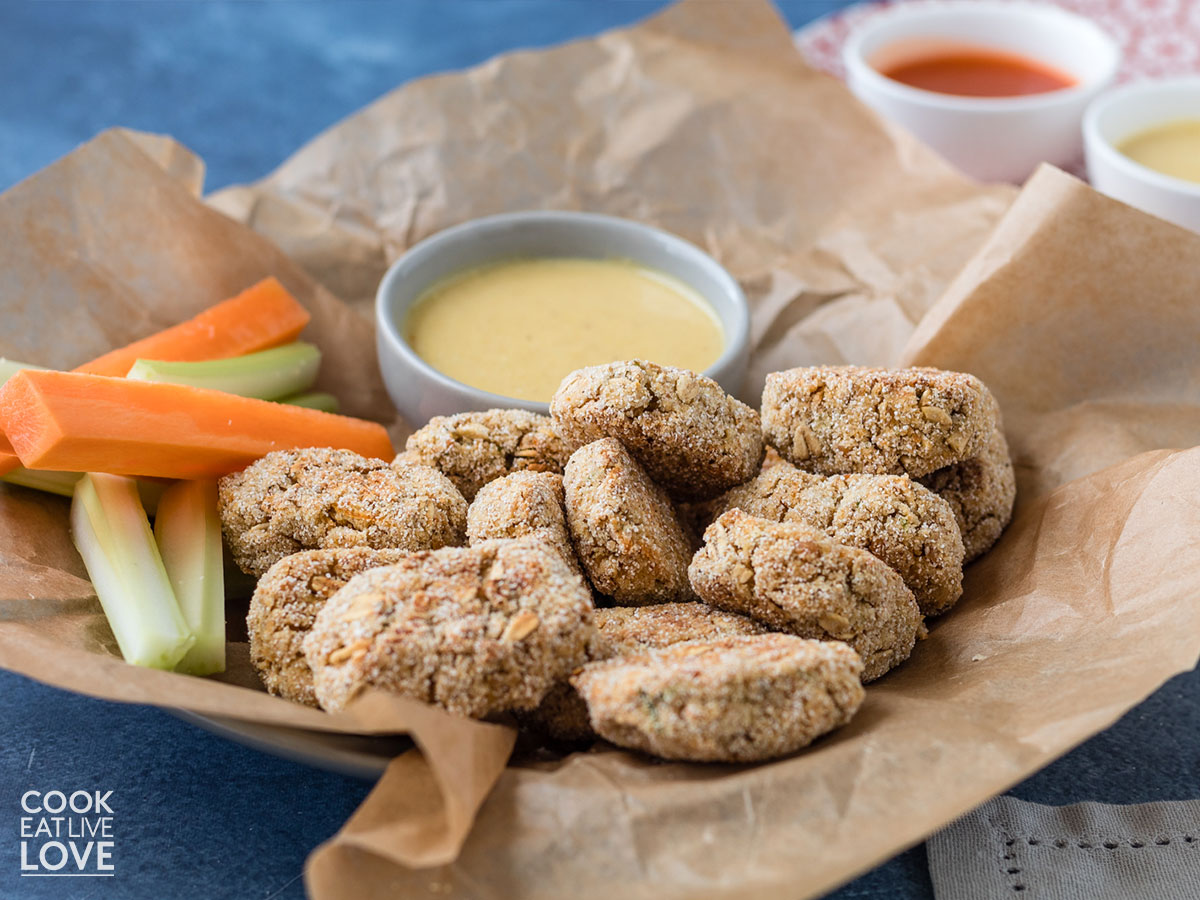 Vegan nuggets with carrot and celery sticks and mustard sauce