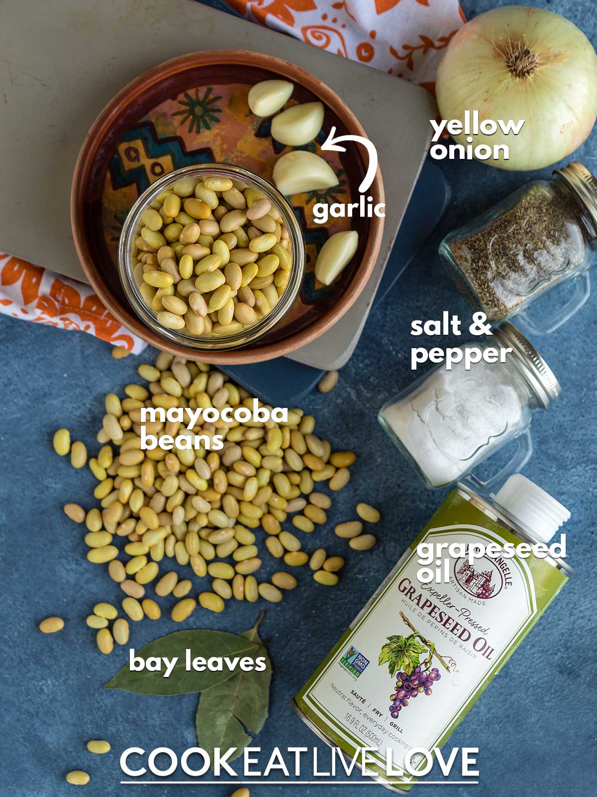 Ingredients to make instant pot mayocoba beans on the table with text labels