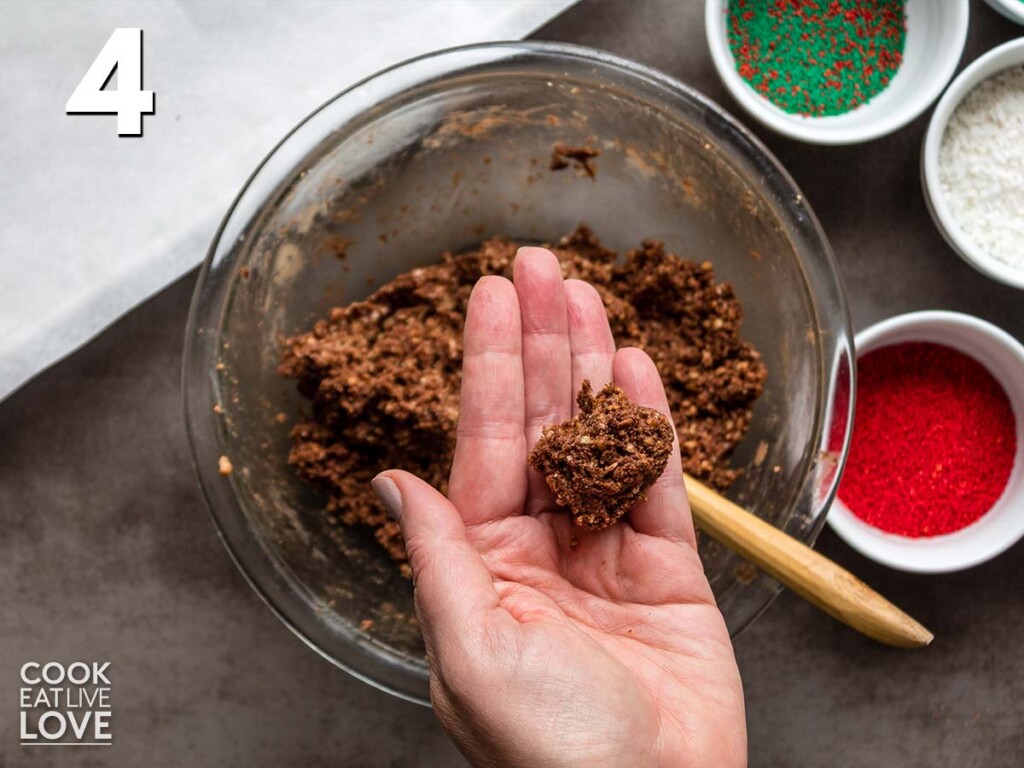 Measure out a small amount of chocolate rum ball cookie dough to shape into balls