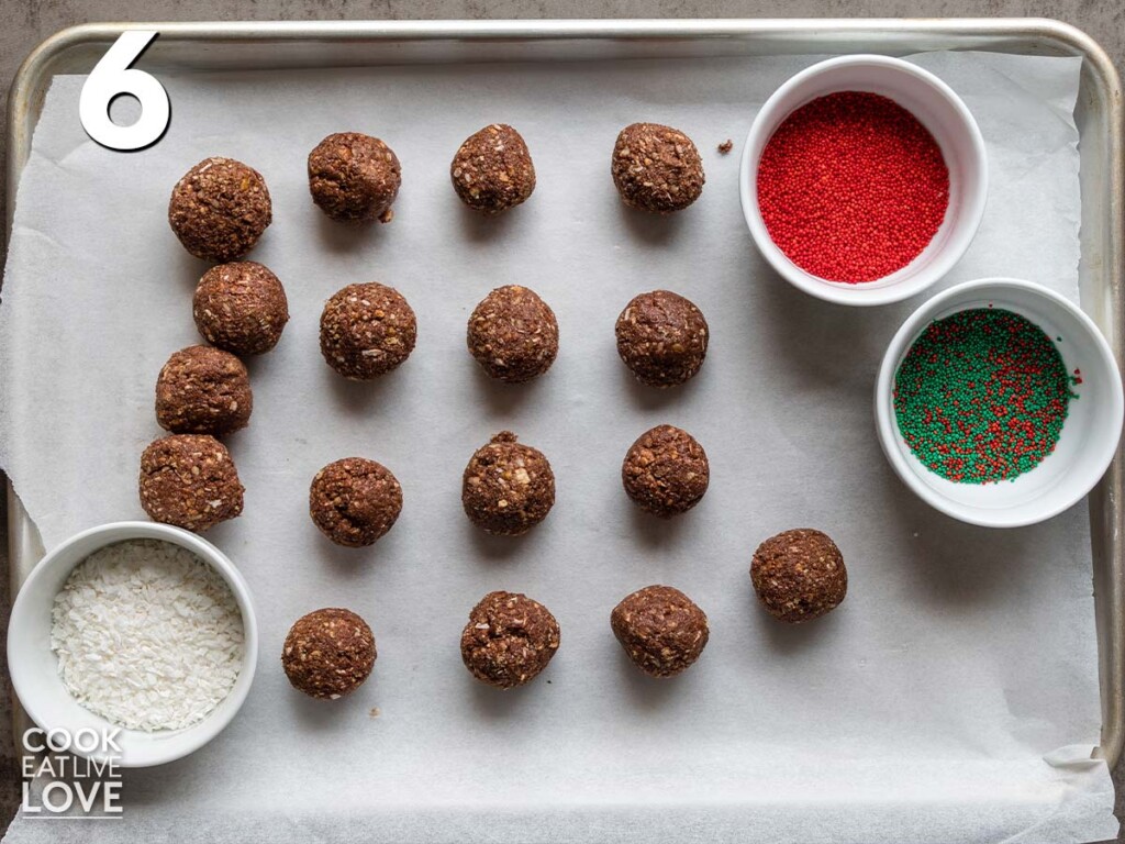 Vegan rum balls rolled on a sheet pan ready to dip in sprinkles