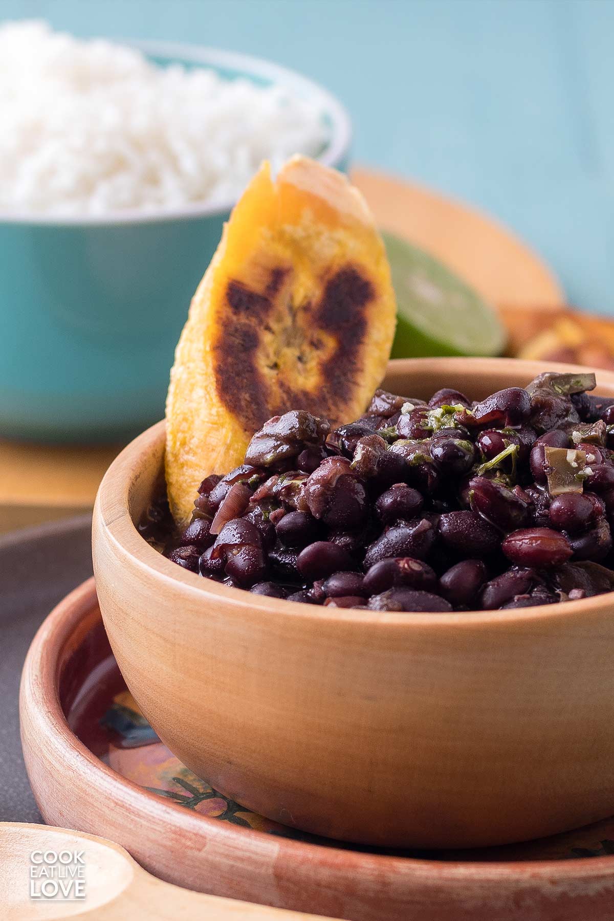 A bowl of instant pot black beans on the table in wooden bowl.