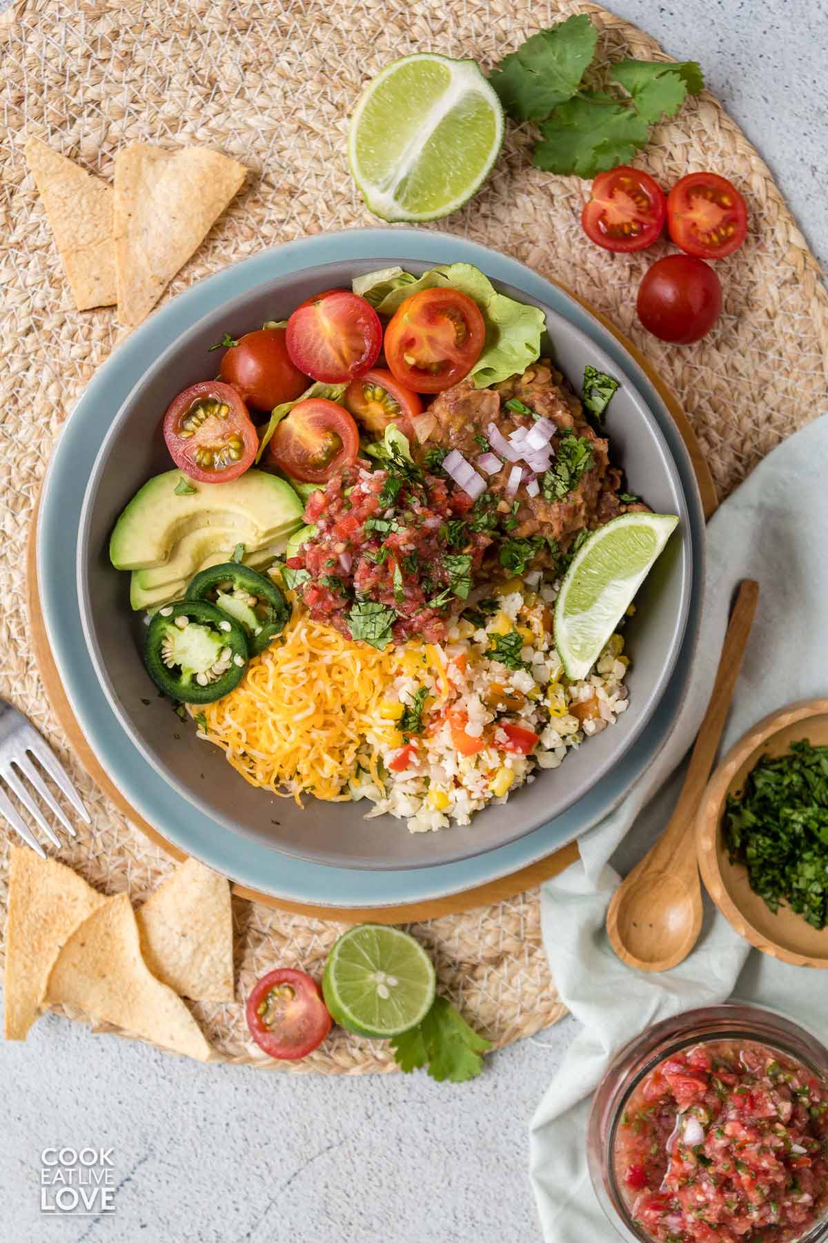 Overhead shot of a vegetarian burrito bowl on the table ready to eat.