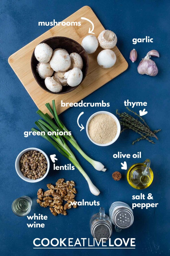 Ingredients to make vegetarian stuffed mushrooms on the table with text labels.
