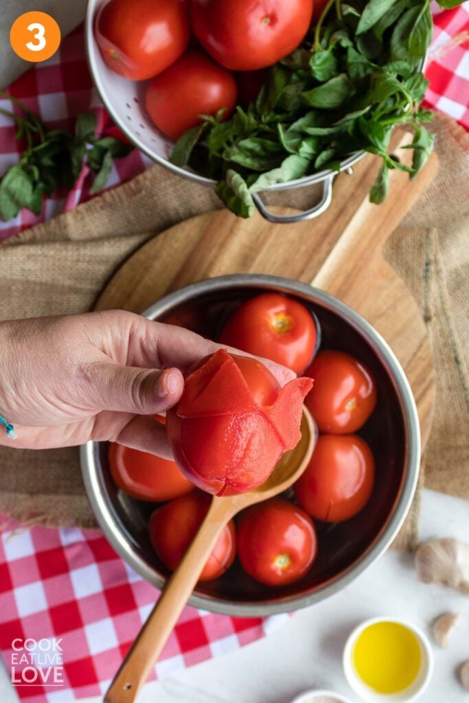 Removing the peel on a tomato.