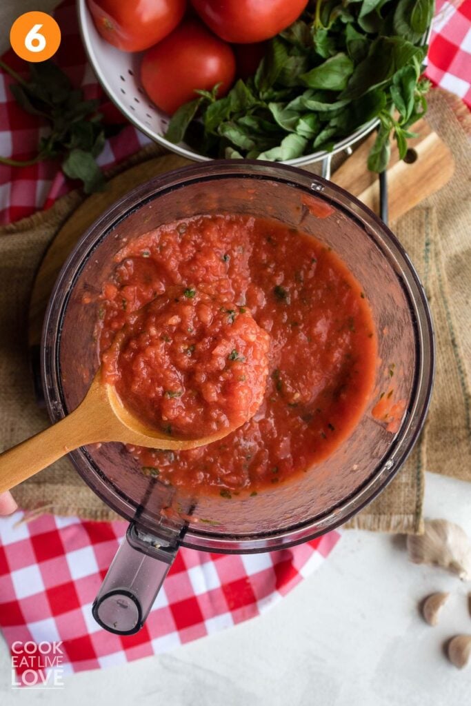Fresh tomato pizza sauce blended in a food processor bowl.