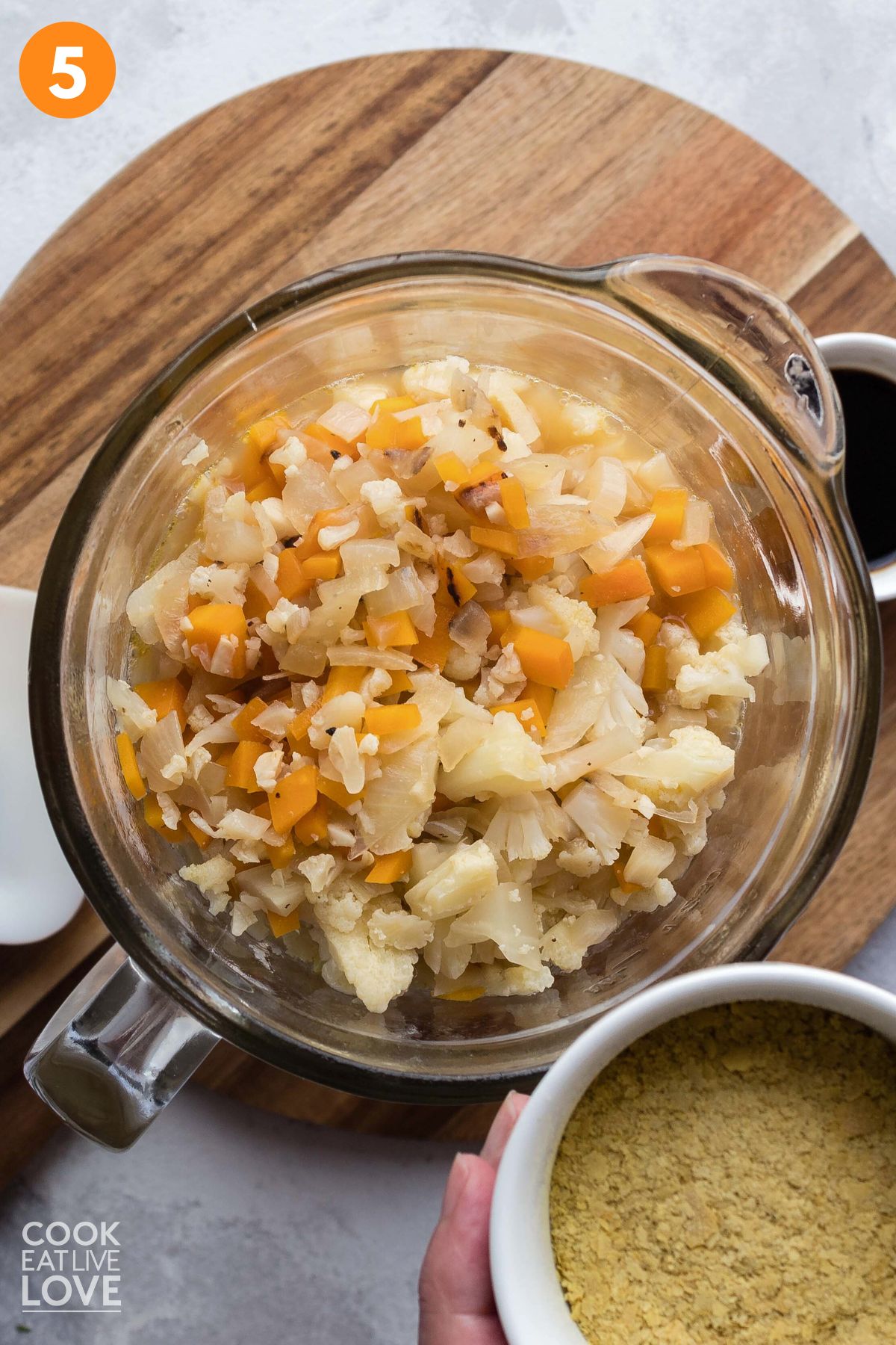 Cooked vegetables added to a blender to make the sauce. 