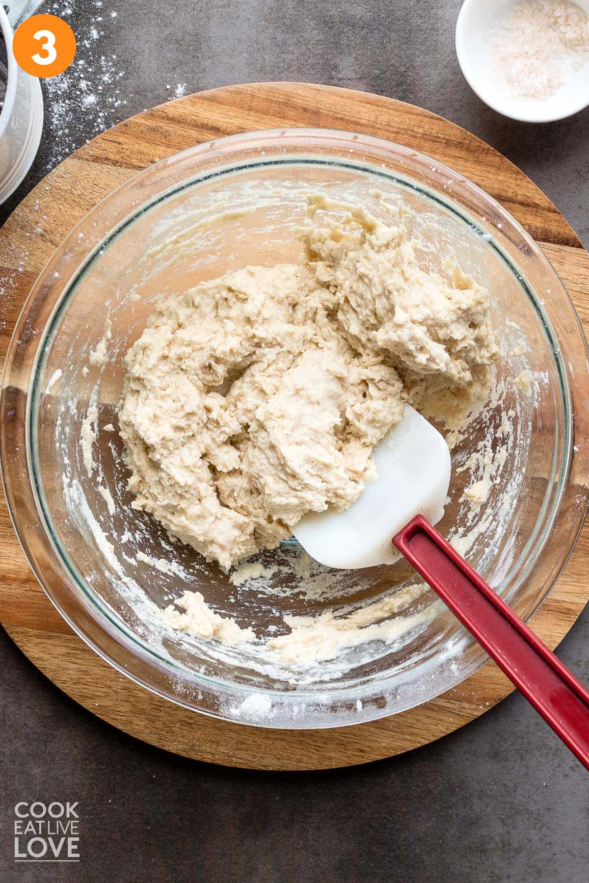 Biscuit dough mixed in a bowl with a spatula.