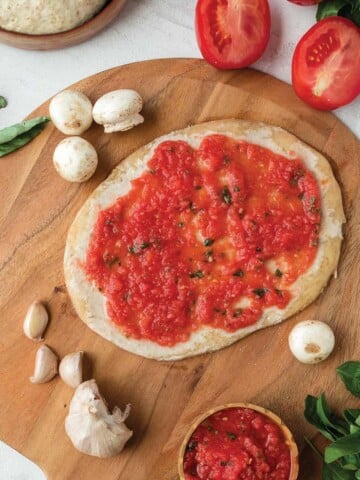 Flatbread pizza crust no yeast with tomato sauce.