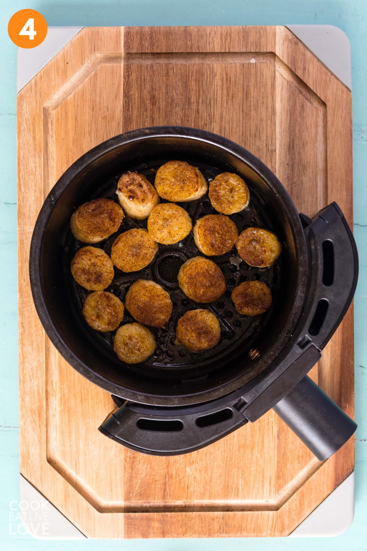 Bananas added to an air fryer basket.